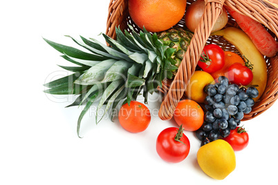 Vegetables and fruits in a basket isolated on white background.