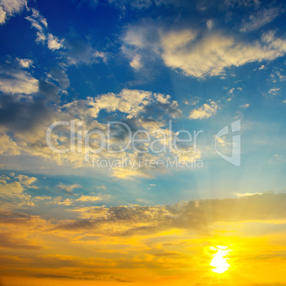 Cloudy sky and bright sunrise over the horizon.