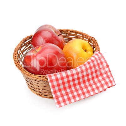 Apples in a wicker basket isolated on white background.
