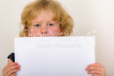 Child holds blank piece of paper