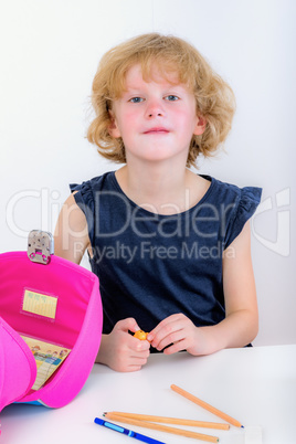 Attentive schoolchild with satchels