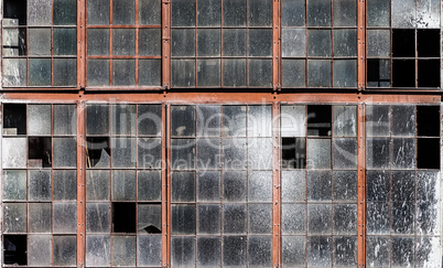 Old building wall with dirty broken windows glass