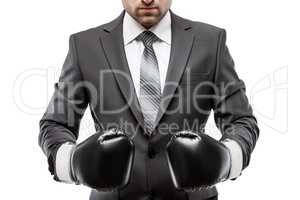 Businessman boxer in black suit wearing sport boxing gloves