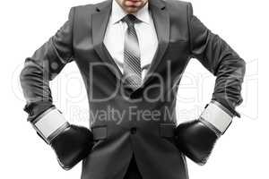 Businessman boxer in black suit wearing sport boxing gloves