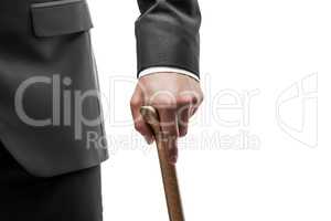 Businessman in black suit holding walking cane stick