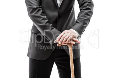 Businessman in black suit holding walking cane stick