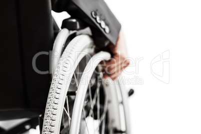 Invalid or disabled businessman in black suit sitting wheelchair
