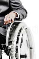 Invalid or disabled businessman in black suit sitting wheelchair