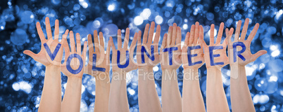 Hands Building Word Volunteer, Glittering And Sparkling Bokeh Background