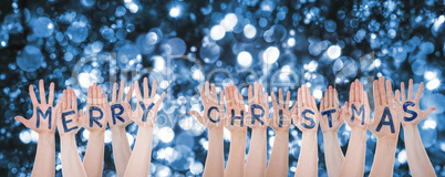 Hands Building Word Merry Christmas, Sparkling Bokeh Background