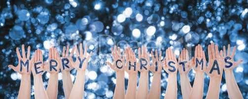 Hands Building Word Merry Christmas, Sparkling Bokeh Background