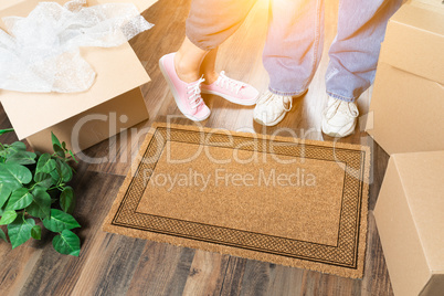 Man and Woman Standing Near Blank Welcome Mat, Moving Boxes