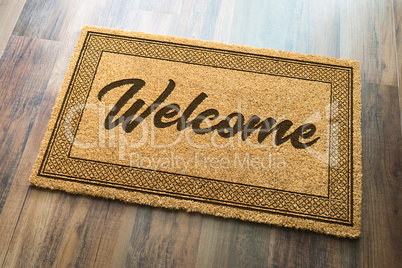Welcome Mat On A Wood Floor Background