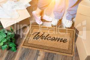 Man and Woman Standing Near Welcome Mat, Moving Boxes and Plant
