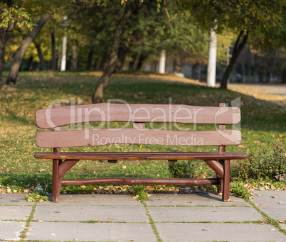 brown wooden bench in city park
