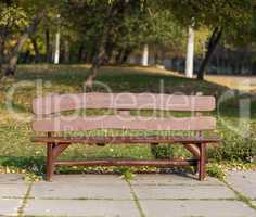 brown wooden bench in city park