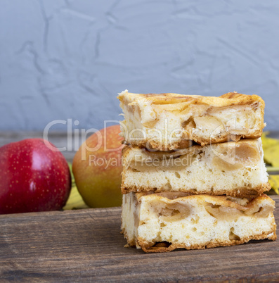 baked sponge cake with apples on the board