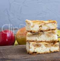 baked sponge cake with apples on the board