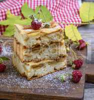 baked square pieces of apple pie are stacked