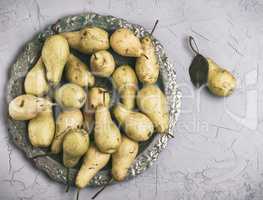 ripe yellow pears in an iron round plate