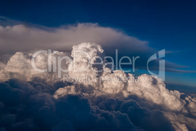 top view of the clouds and the blue sky from the plane window, the background of nature.