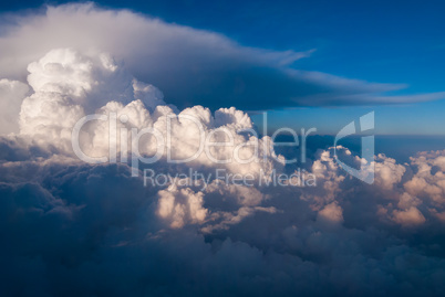 top view of the clouds and the blue sky from the plane window, the background of nature.