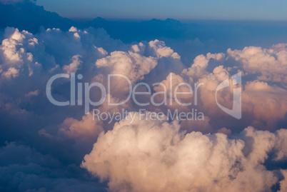 top view of the clouds and the blue sky from the plane window, the background of nature.