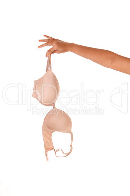 Woman's arm holding a beige bra