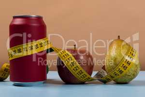 healthy life contrast with can of soda and fruit with a tape measure