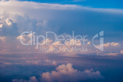 top view of the clouds and the blue sky from the plane window, the background of nature.