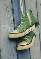 pair of used green textile shoes hang