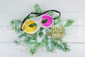 A wreath of fir branches, a mask and a decorative star on a whit