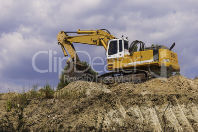 Excavator on the construction site is preparing to load the soil