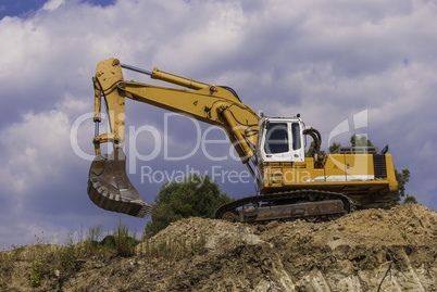 Excavator on the construction site is preparing to load the soil