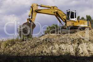Excavator on the construction site is preparing to load the soil