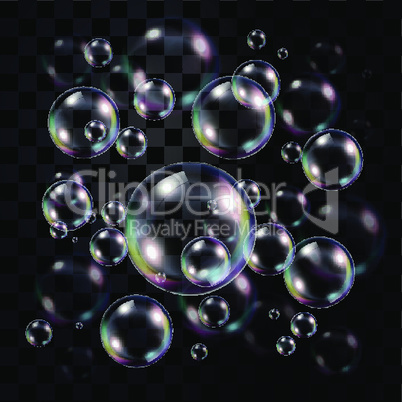 Transparent and multicolored soap bubbles over dark