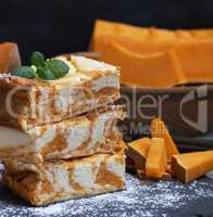 square pieces of baked cheesecake cottage cheese with pumpkin