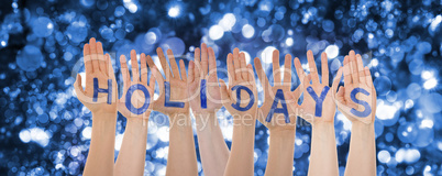 Hands Building Word Holidays, Glittering And Sparkling Bokeh Background