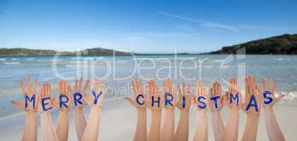 Many Hands Building Word Merry Christmas, Beach And Ocean