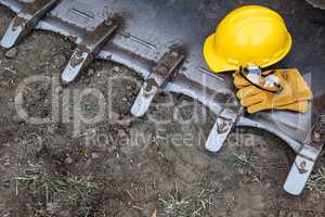 Hardhat, Gloves and Protective Glasses Resting on Bulldozer