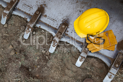 Hardhat, Gloves and Protective Glasses Resting on Bulldozer