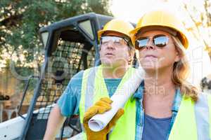 Male and Female Workers With Technical Blueprints