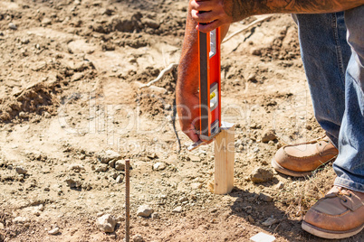 Worker Using Level At Constrcution Site