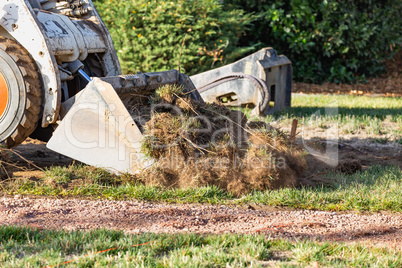 Small Bulldozer Removing Grass From Yard Preparing For Pool