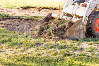 Small Bulldozer Removing Grass From Yard Preparing For Pool