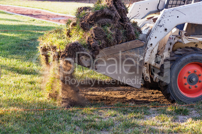 Small Bulldozer Removing Grass From Yard Preparing For Pool