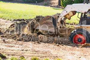 Small Bulldozer Digging In Yard For Pool Installation
