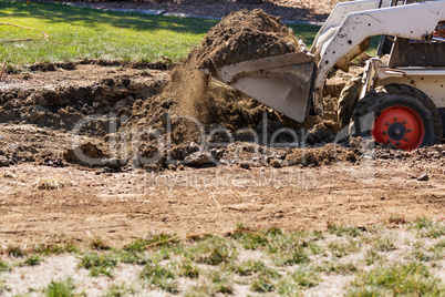 Small Bulldozer Digging In Yard For Pool Installation