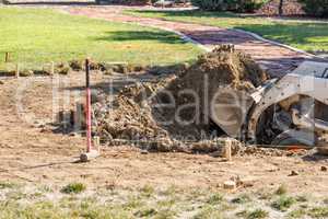 Small Bulldozer Digging In Yard For Pool Installation