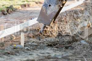 Small Bulldozer Using A Breaker Attachment To Dig Hole